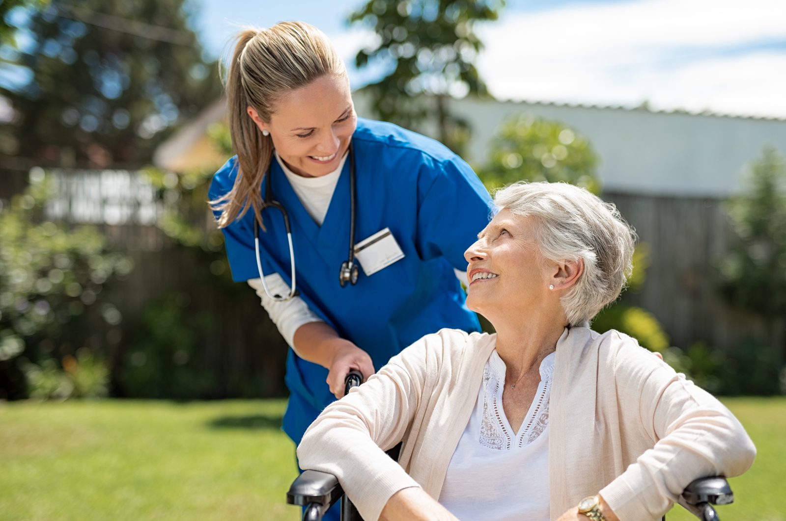 Caregiver checking an older adult\'s blood pressure at home