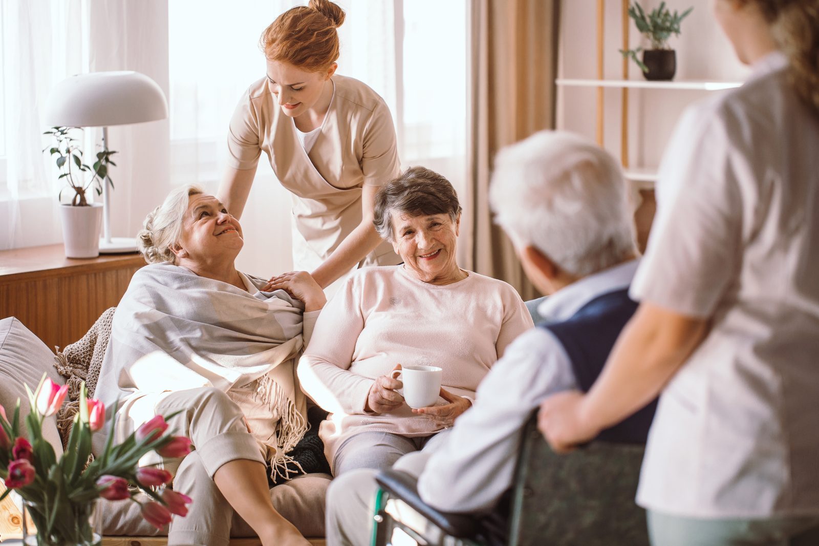 Caregiver sharing a warm, joyful moment with an older adult
